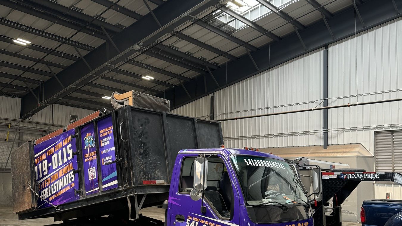 541 Junk Removal truck loaded inside a shop during a commercial clean-out