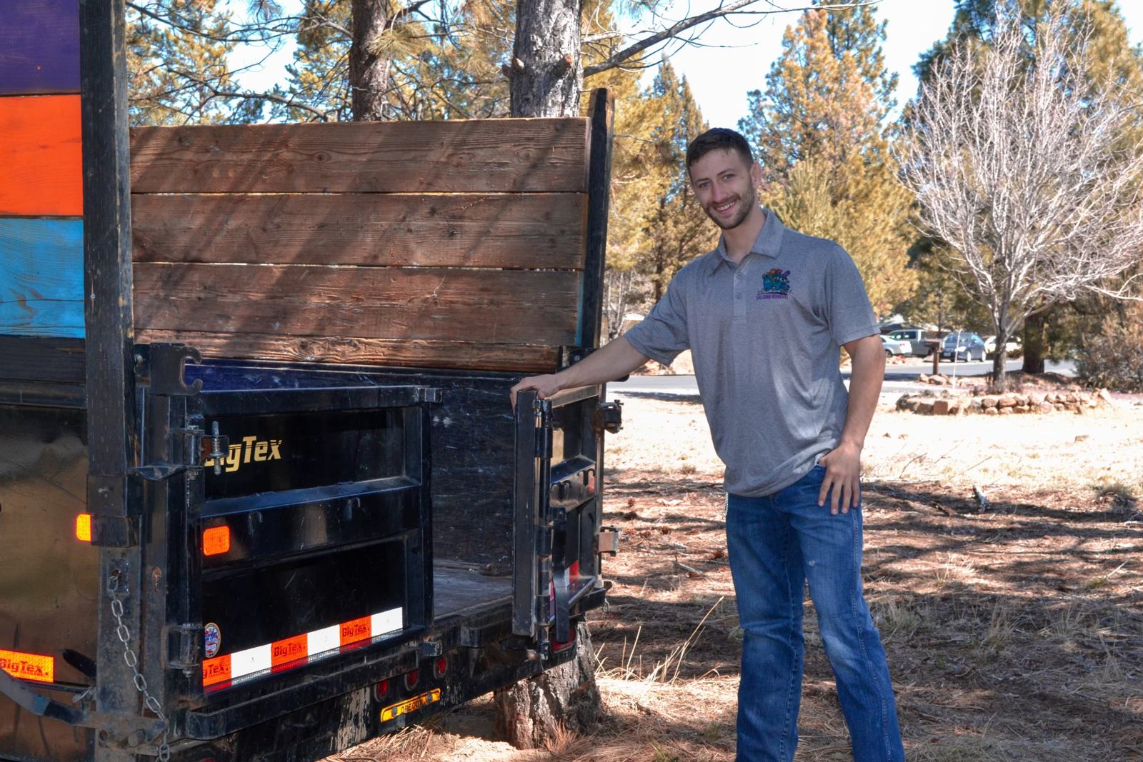 One of the 541 Junk Removal crew with our dump trailer on a job in the pines near Bend, Oregon