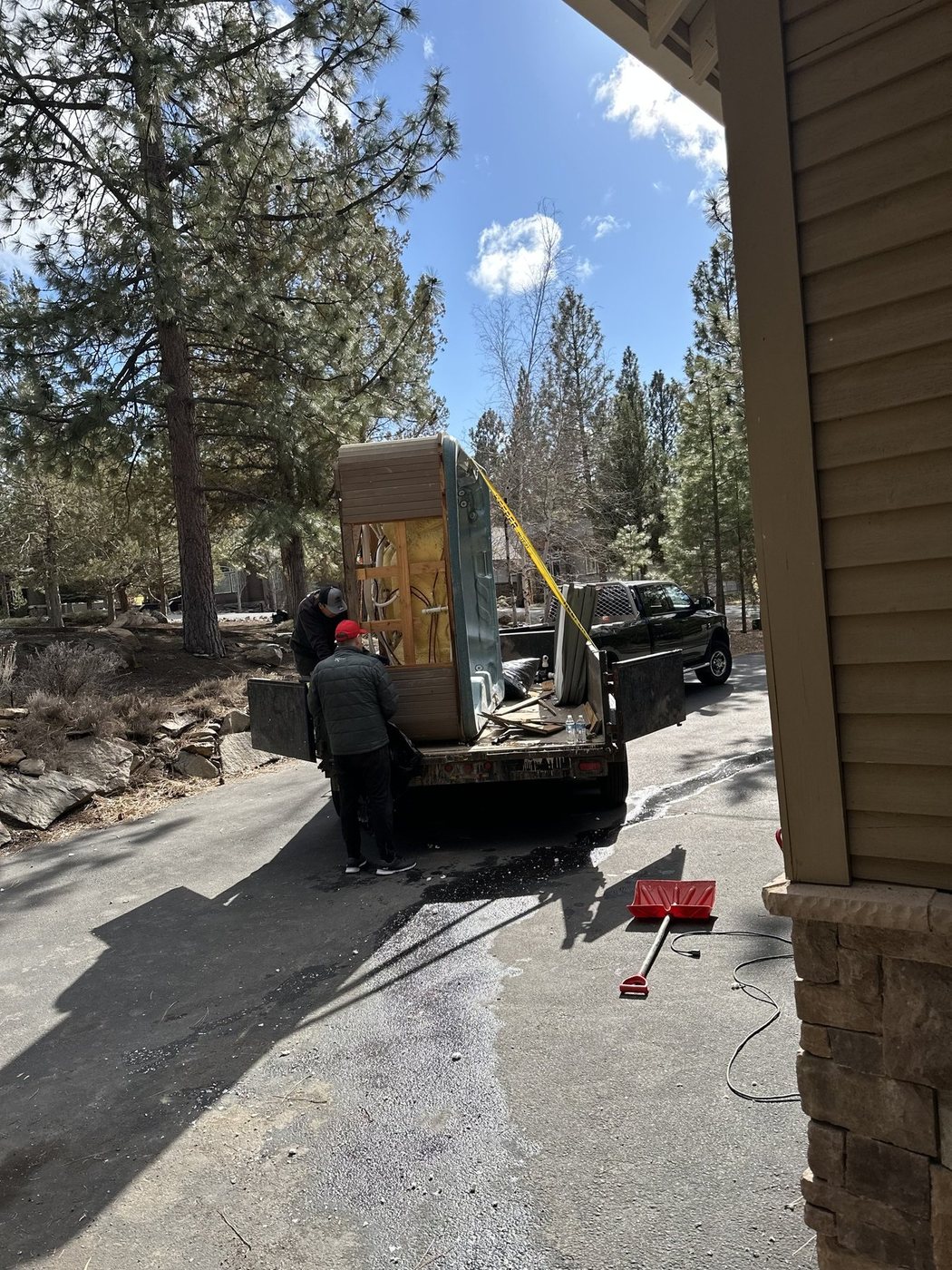 Hot tub lifted out and loaded for disposal in Bend